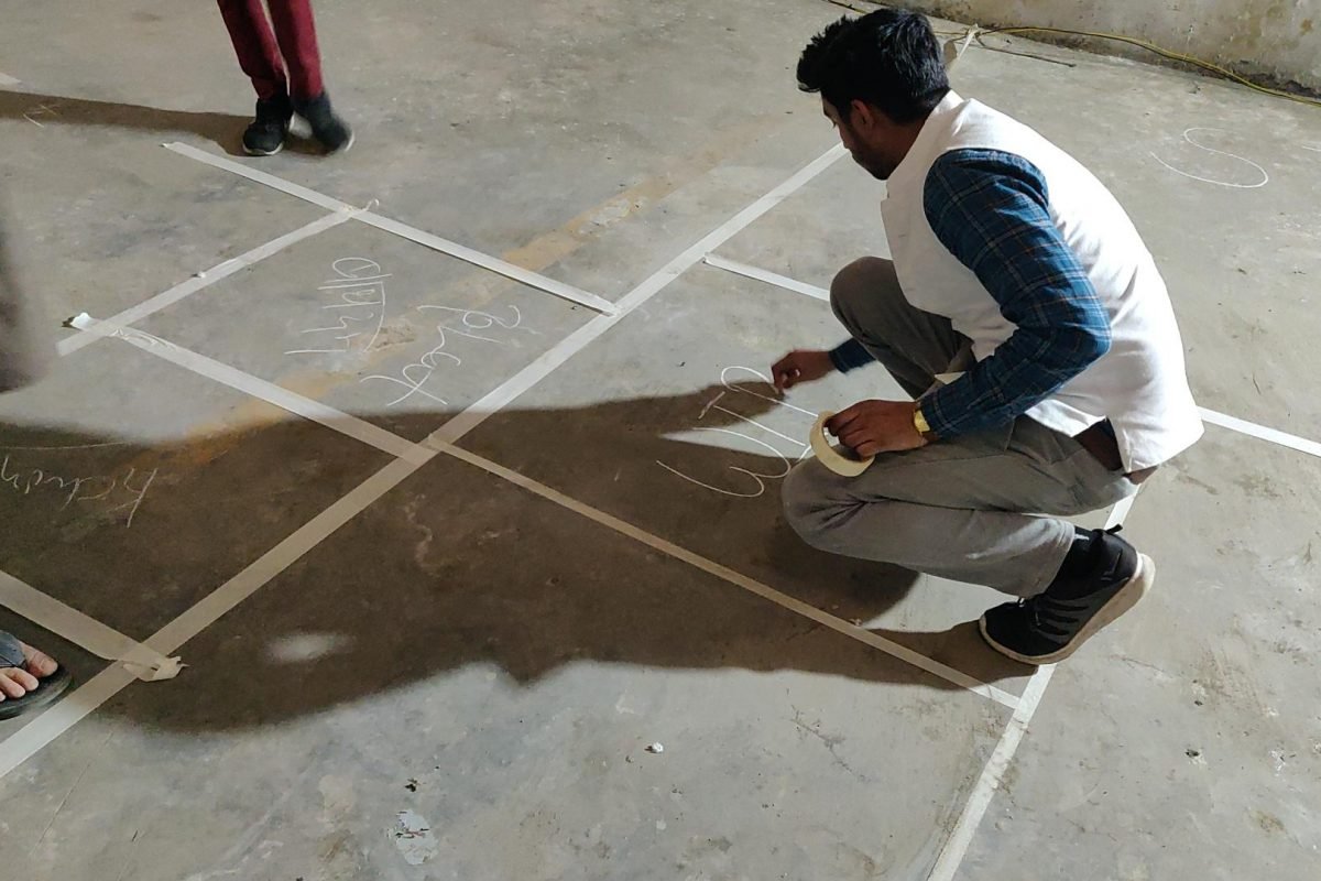 Man labeling floorplan with chalk