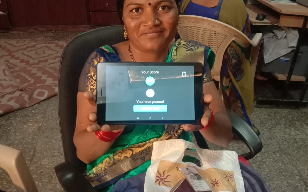 A woman holding up a digital tablet