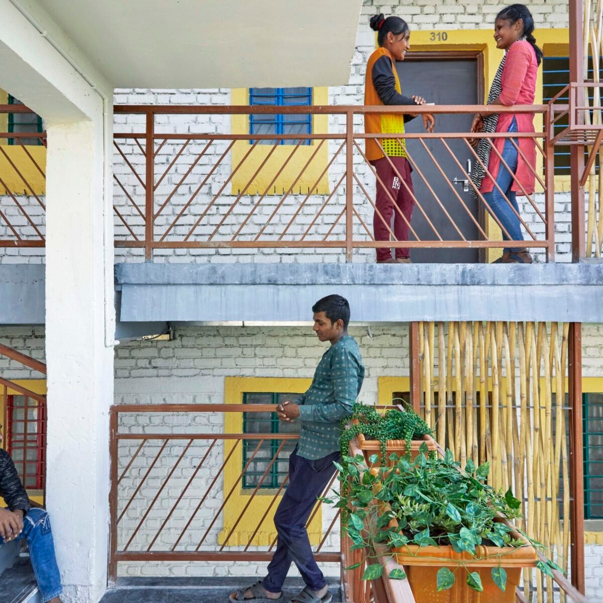 The staircase connecting building is also serving as a common space for residents to gather and meet